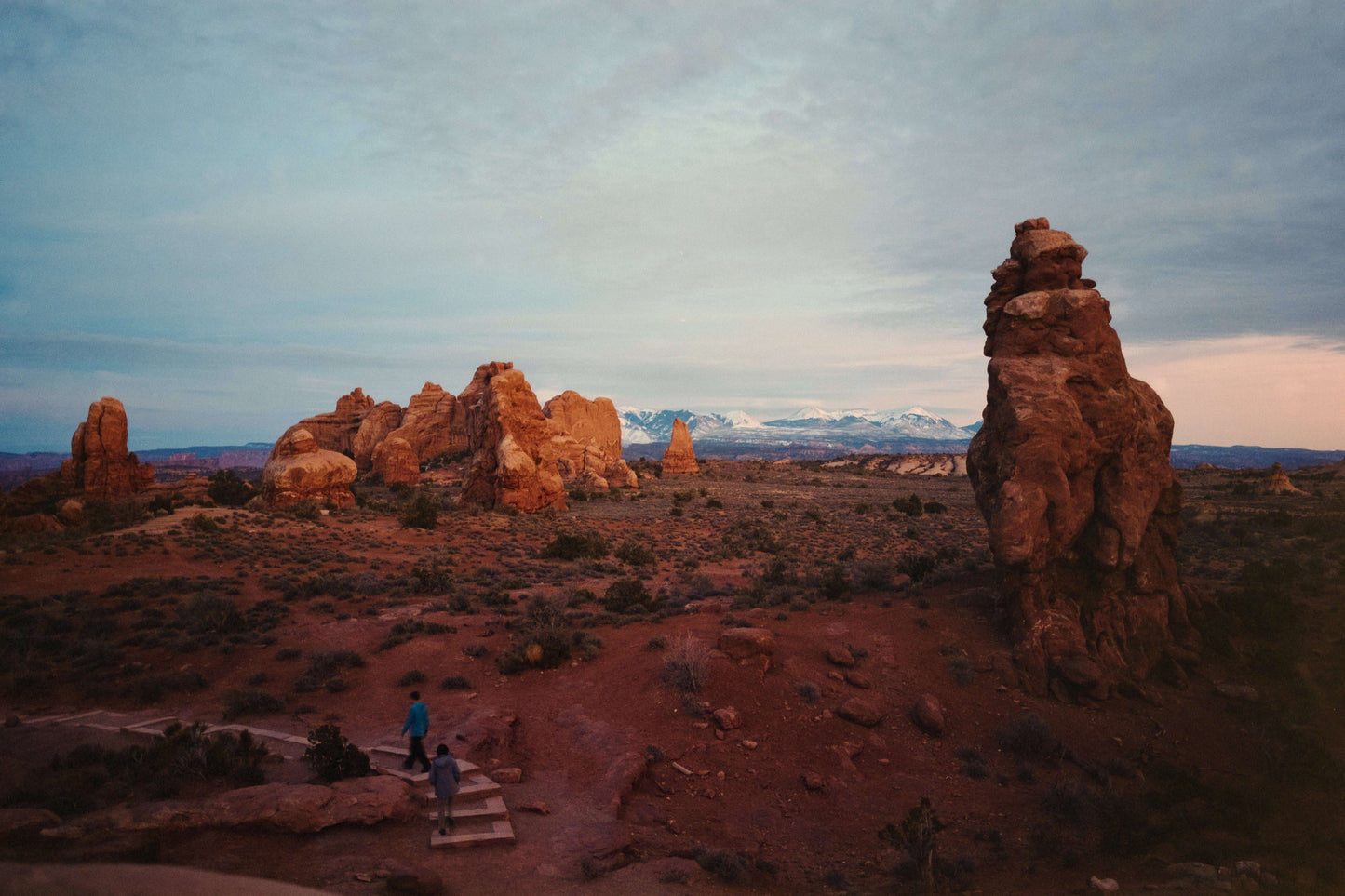Scenic view of Arches National Park with natural rock formations at dusk.