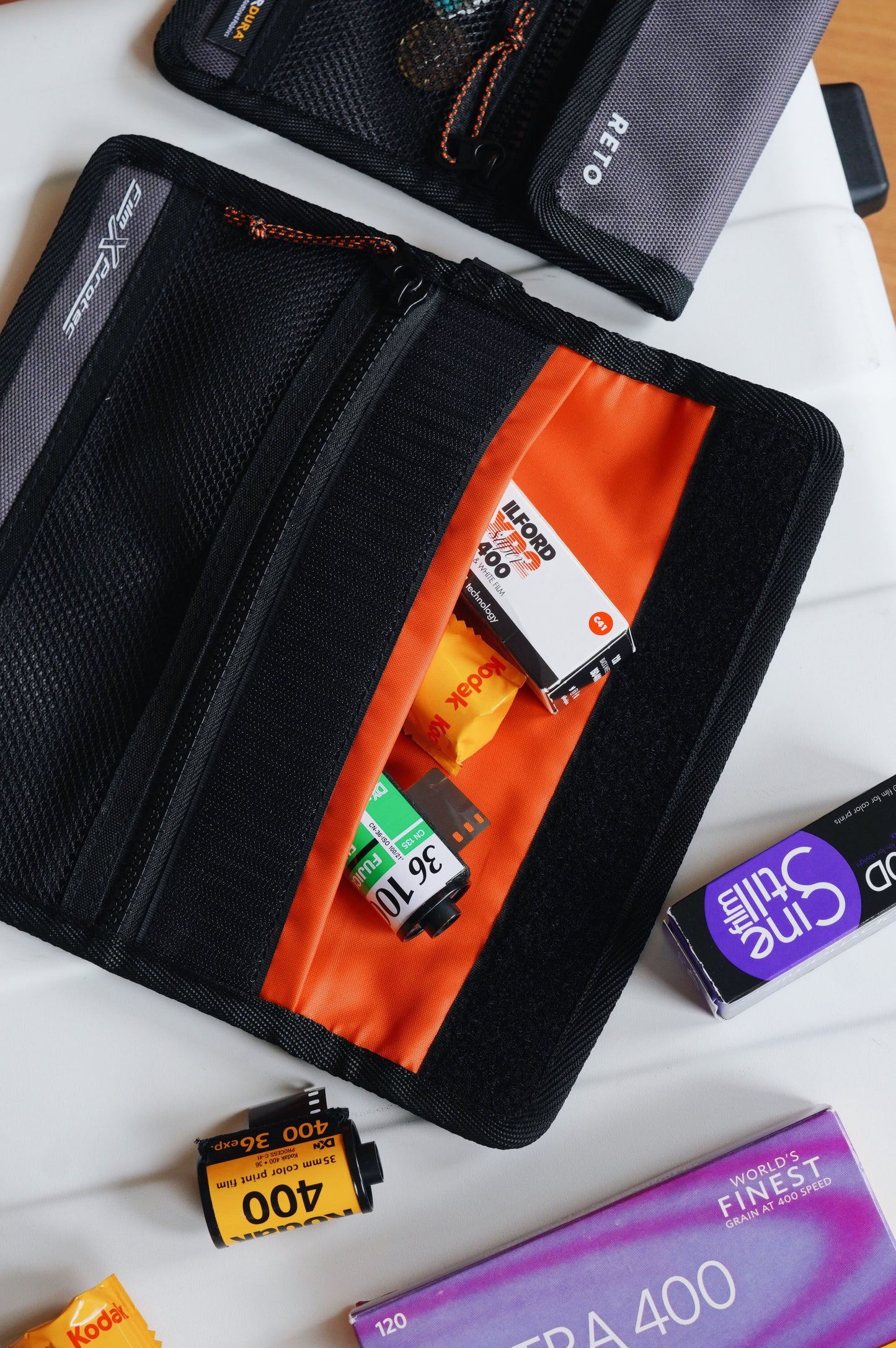 RETO Film X-Protec Bag (Medium) showcasing orange interior with 35 mm film rolls neatly organized inside.