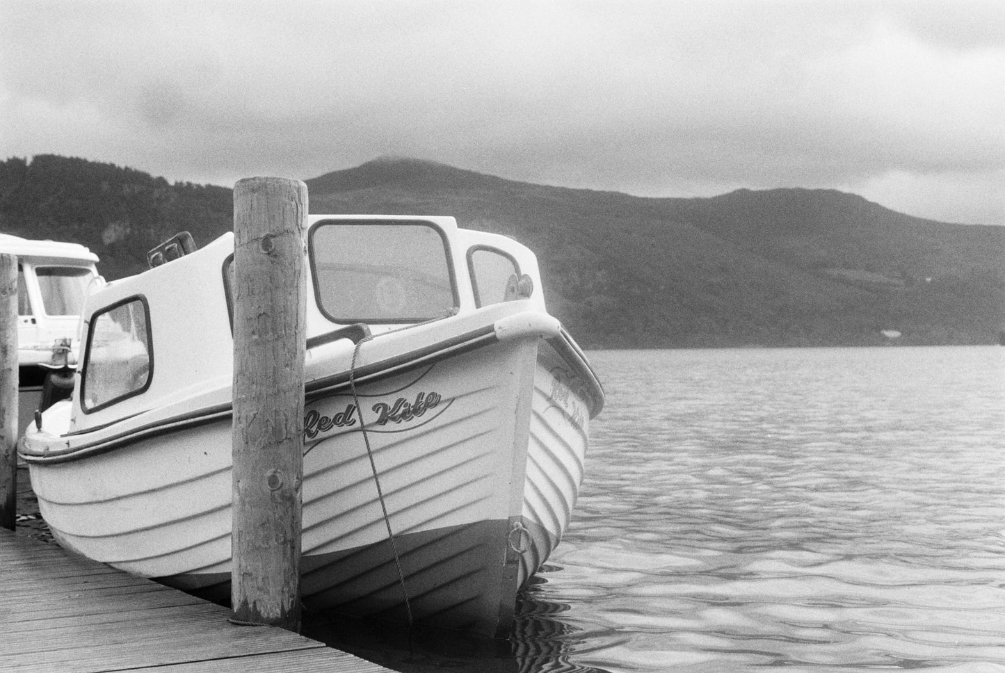 Ilford HP5 Plus B&W Single-Use Film Camera (35mm, 27 Exposures) on a dock with a classic boat, shot with Ilford HP5 Plus B&W Single-Use Film Camera