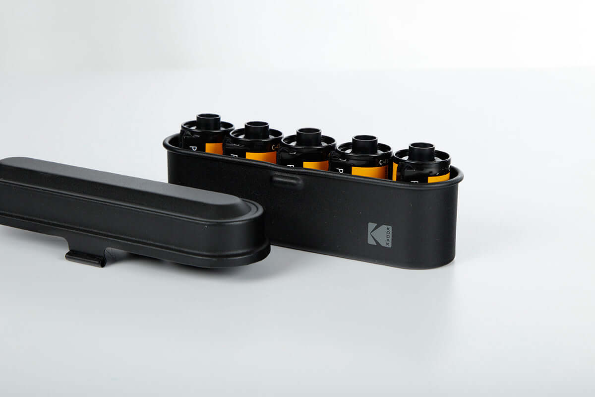 Open view of a Kodak 135 film case in the color green.