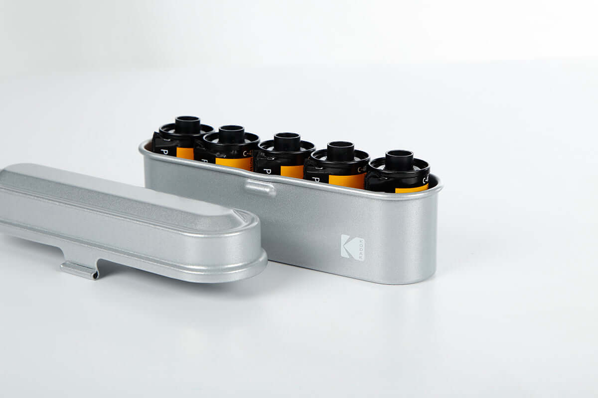 Open view of a Kodak 135 film case in the color silver.