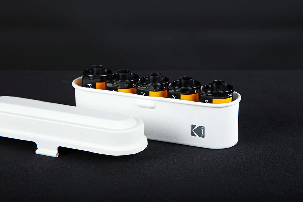 Open view of a Kodak 135 film case in the color white.