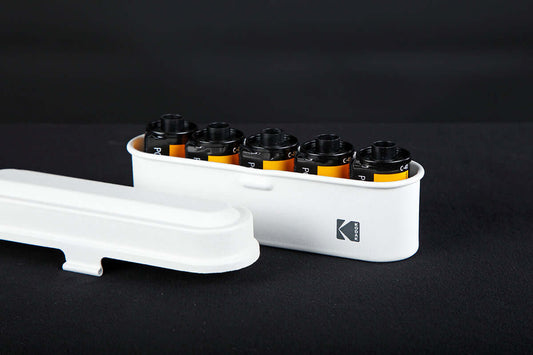 Open view of a Kodak 135 film case in the color white.