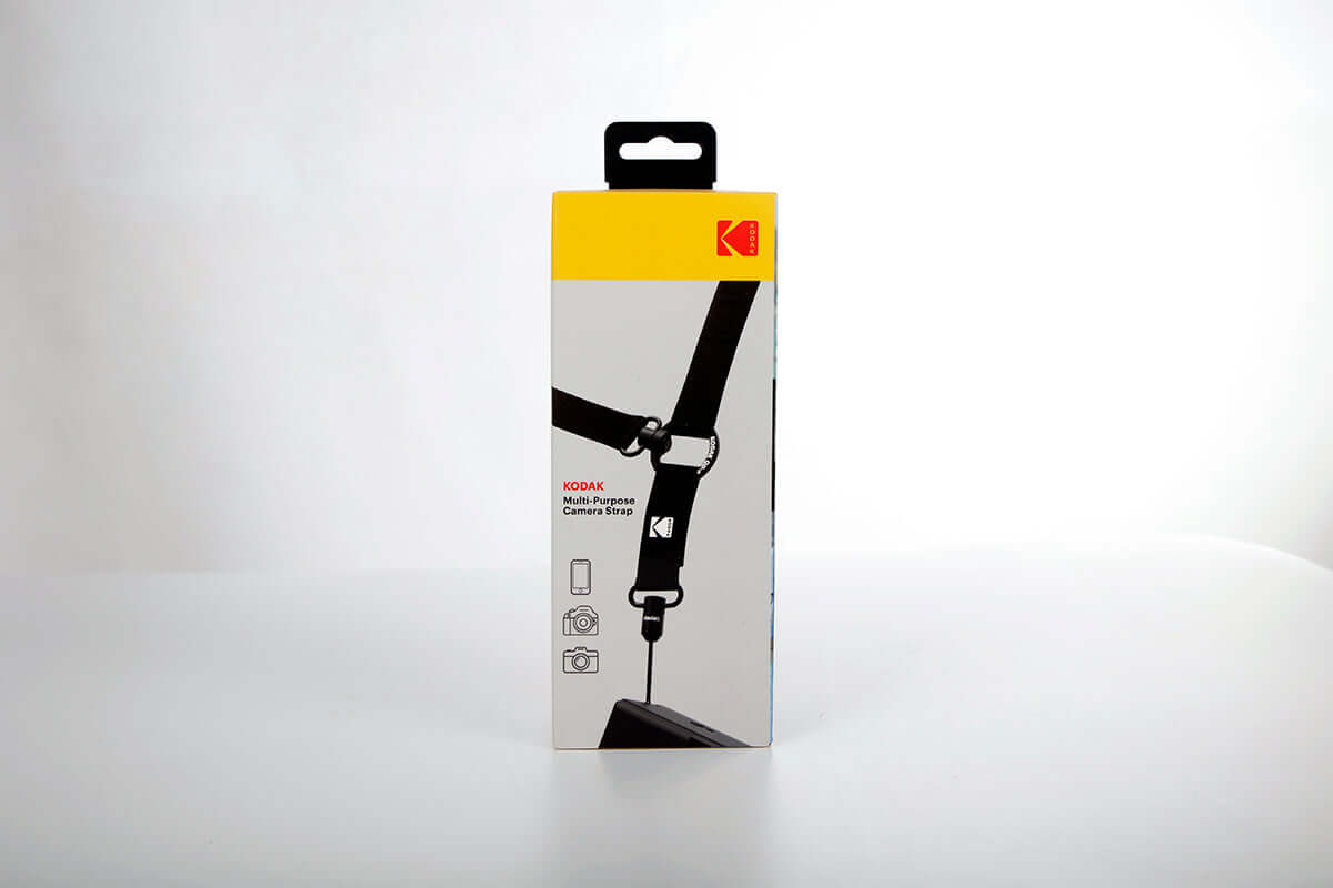 Kodak Multi-Purpose Camera Strap (Black) packaging with adjustable neck and crossbody strap design.