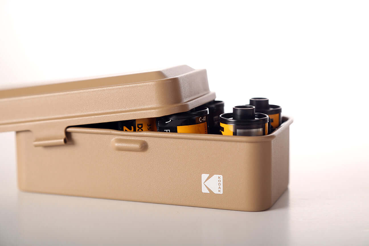 Open view of a Kodak 135 film case in the color beige.