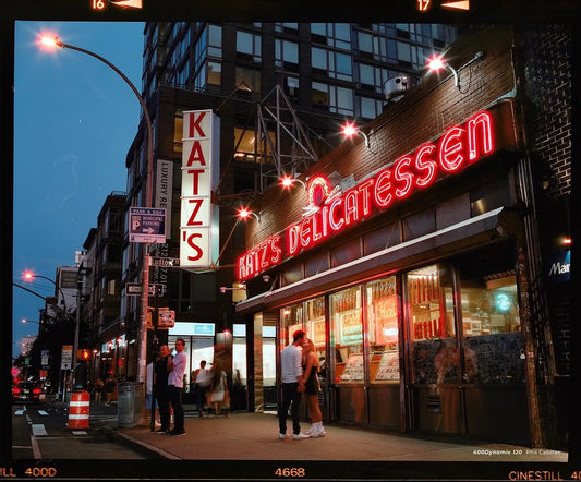 Katz's Delicatessen neon sign at dusk, showcasing iconic New York eatery and vibrant street scene, shot on CineStill 400Dynamic