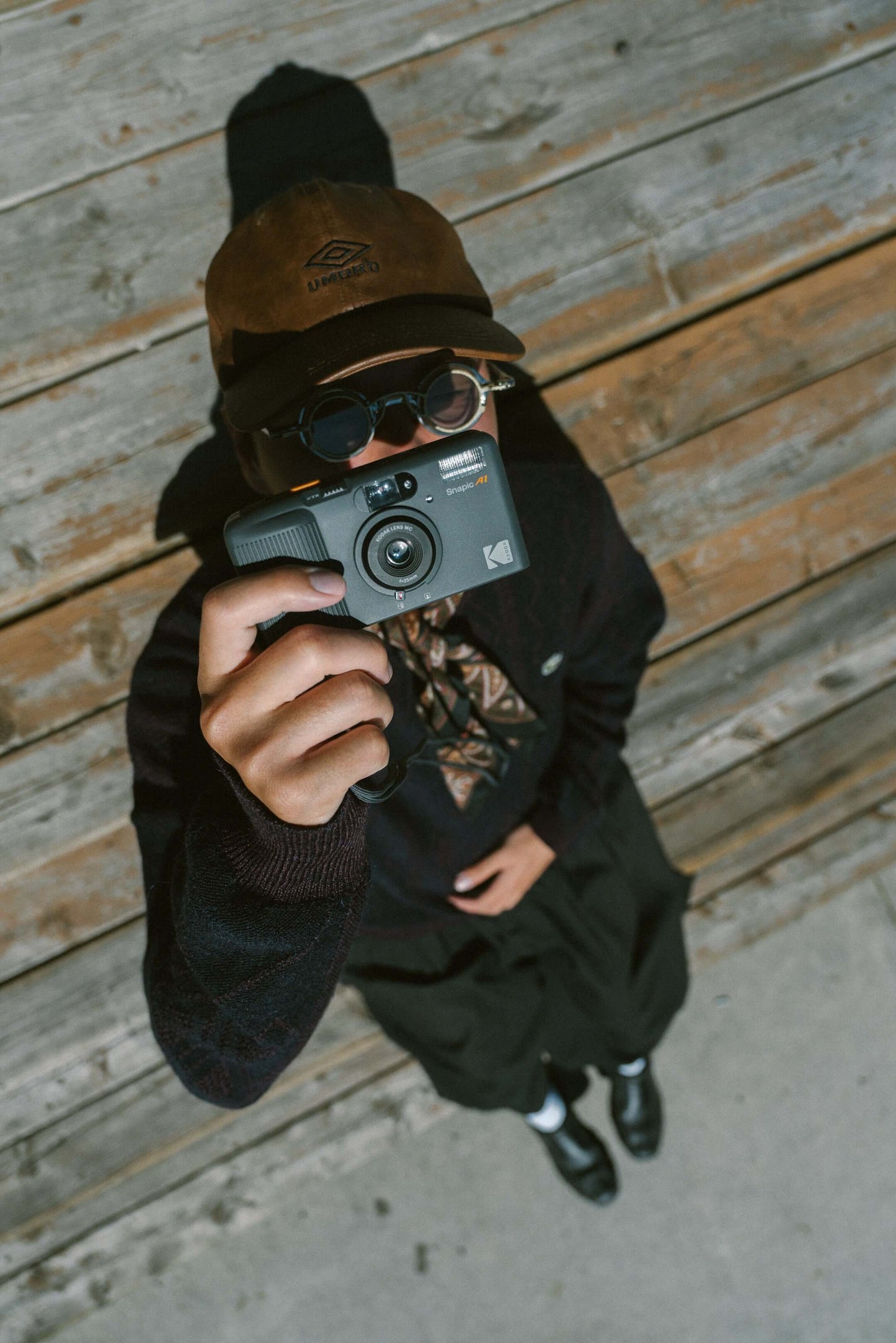 Person holding the Kodak Snapic A1 35mm camera pointing at the ceiling.