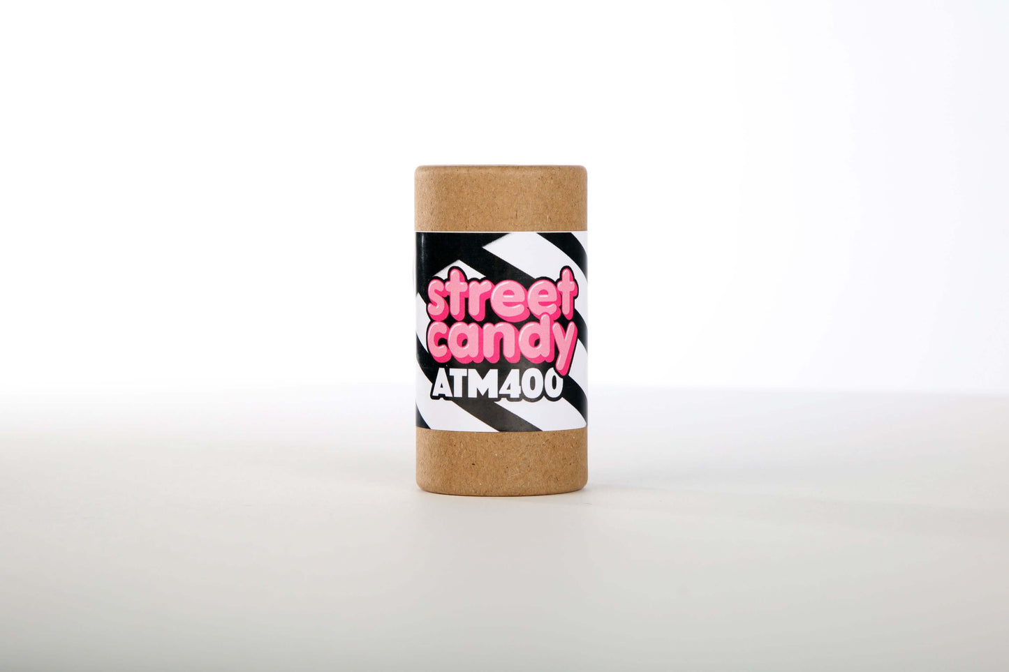 Street Candy ATM400 Black and White Negative Film (35mm Roll, 36 Exposures) in a cylindrical container on a light background.