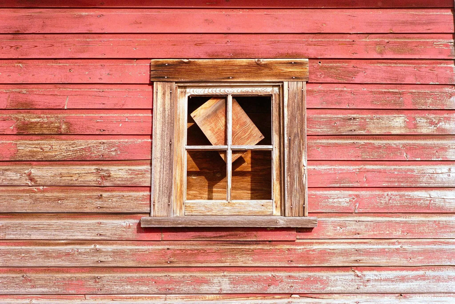 Street Candy Street Savvy Sample Image: Rustic window on a weathered red barn wall with wooden frame and interior wooden box.