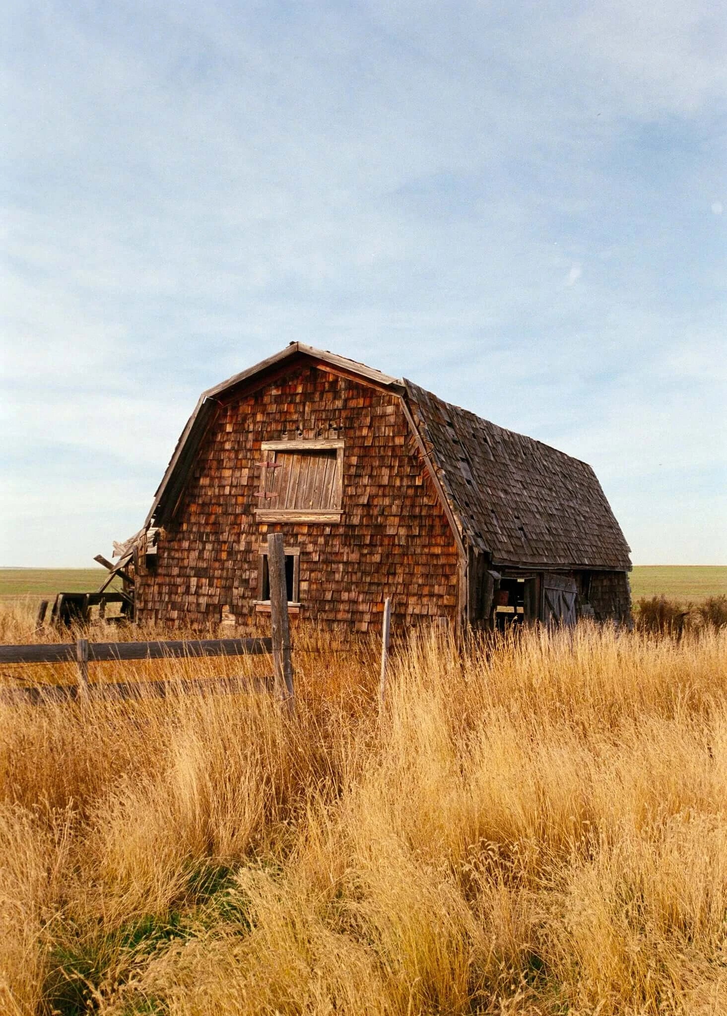 Street Candy Street Savvy Sample Image: rustic wooden barn surrounded by tall grass under a clear blue sky in a rural landscape