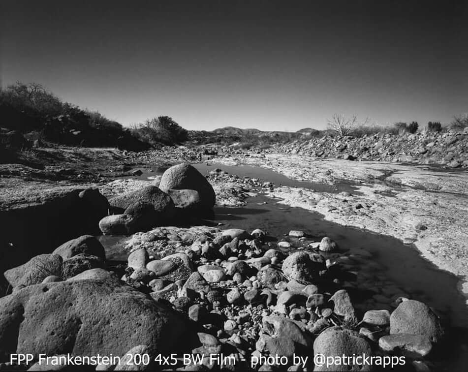 Film Photography Project Frankenstein 200 black and white landscape scene showing rocks and riverbed with high contrast
