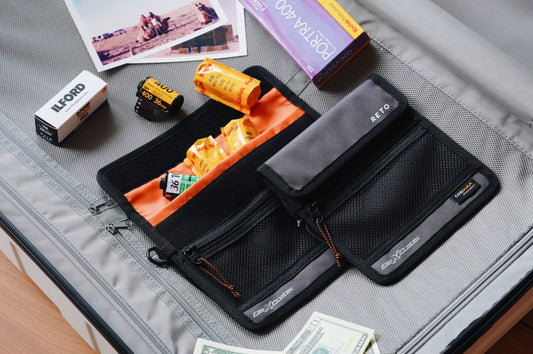 Traveling with film essentials, including film rolls, storage containers, and photography accessories.