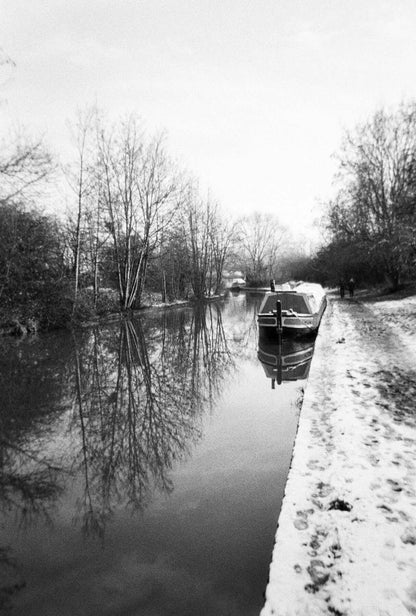 Harman EZ-35 Reusable 35mm Film Camera on canal edge with boat, Ilford HP5 Plus 400 vibe, showcasing compact travel setup and 36 exposures included