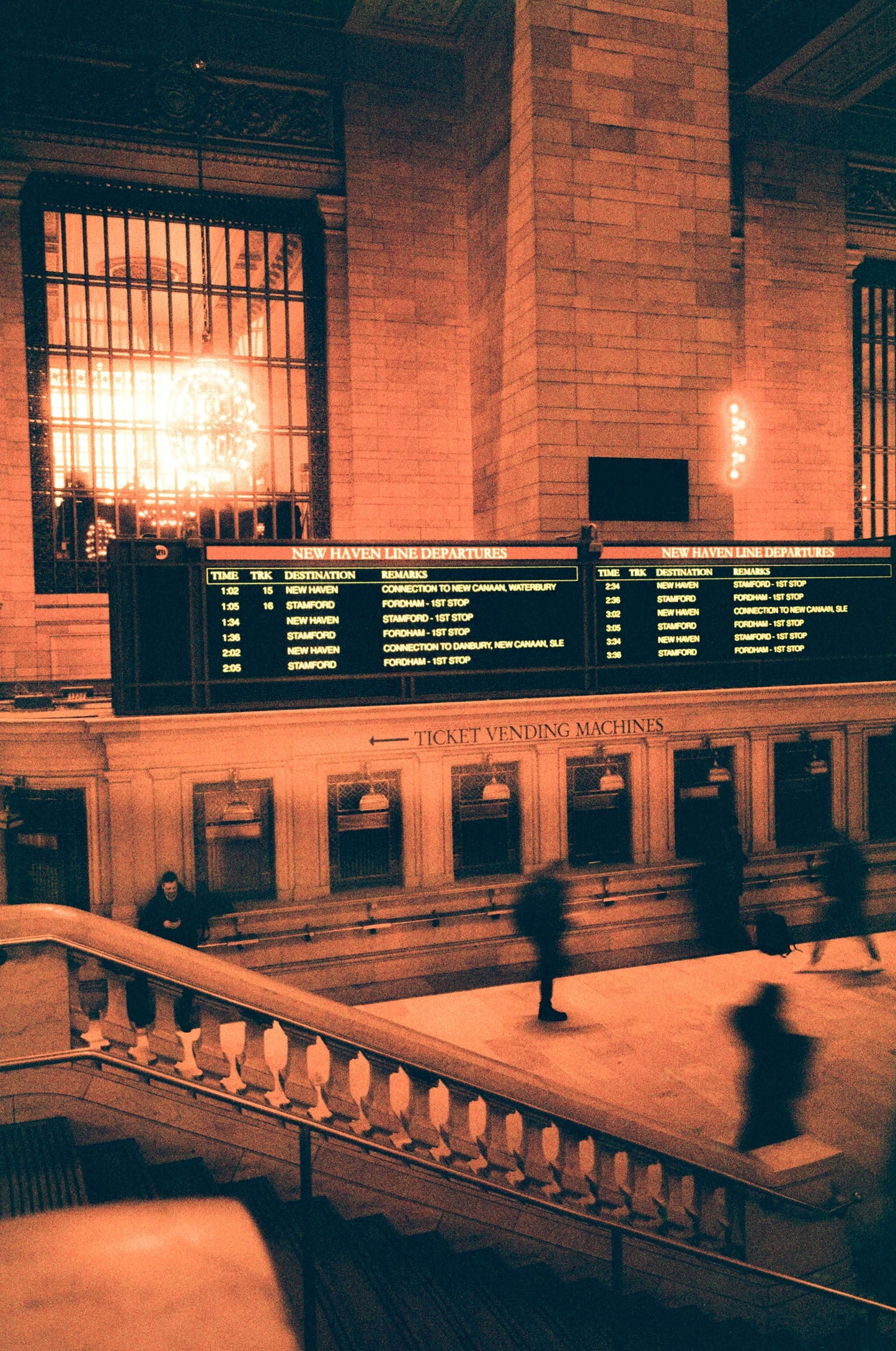 Historic train station interior with ticket vending machines and departure board, shot on Harman Red 125.