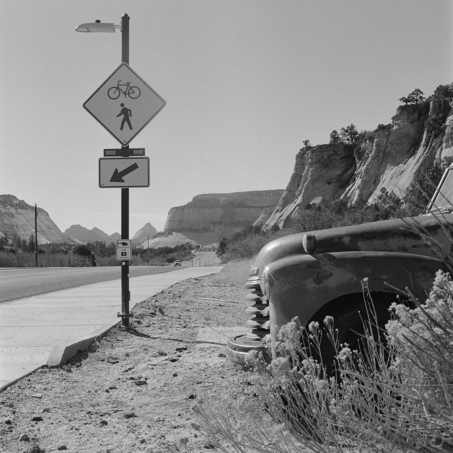 Kodak Tri-X 400 Black and White Negative Film (120 Roll Film, 5-Pack) capturing a vintage car by a road sign in monochrome.