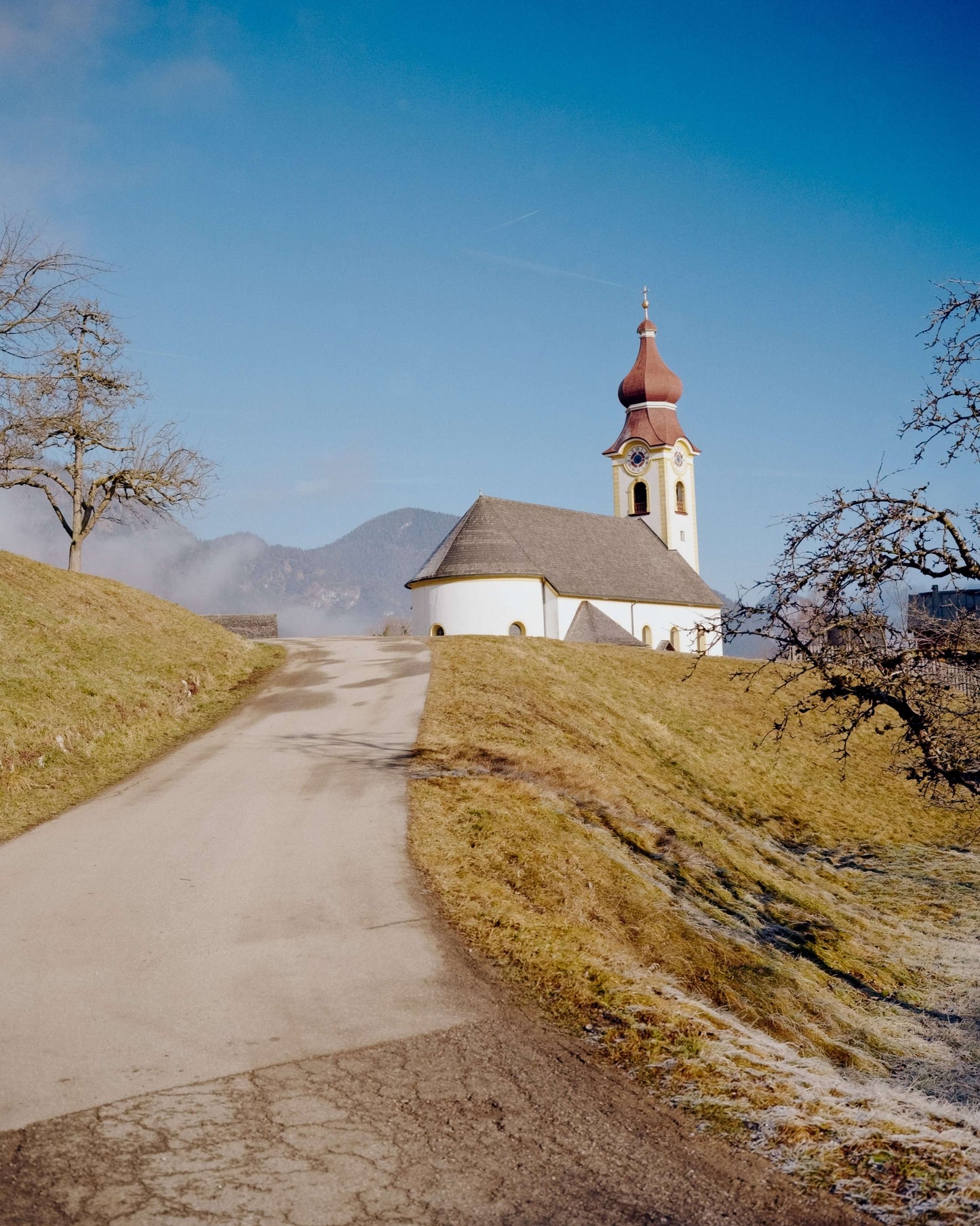 Kodak Eastman Gold 200 Color Negative Film captured a scenic church on a hill with a clear blue sky.