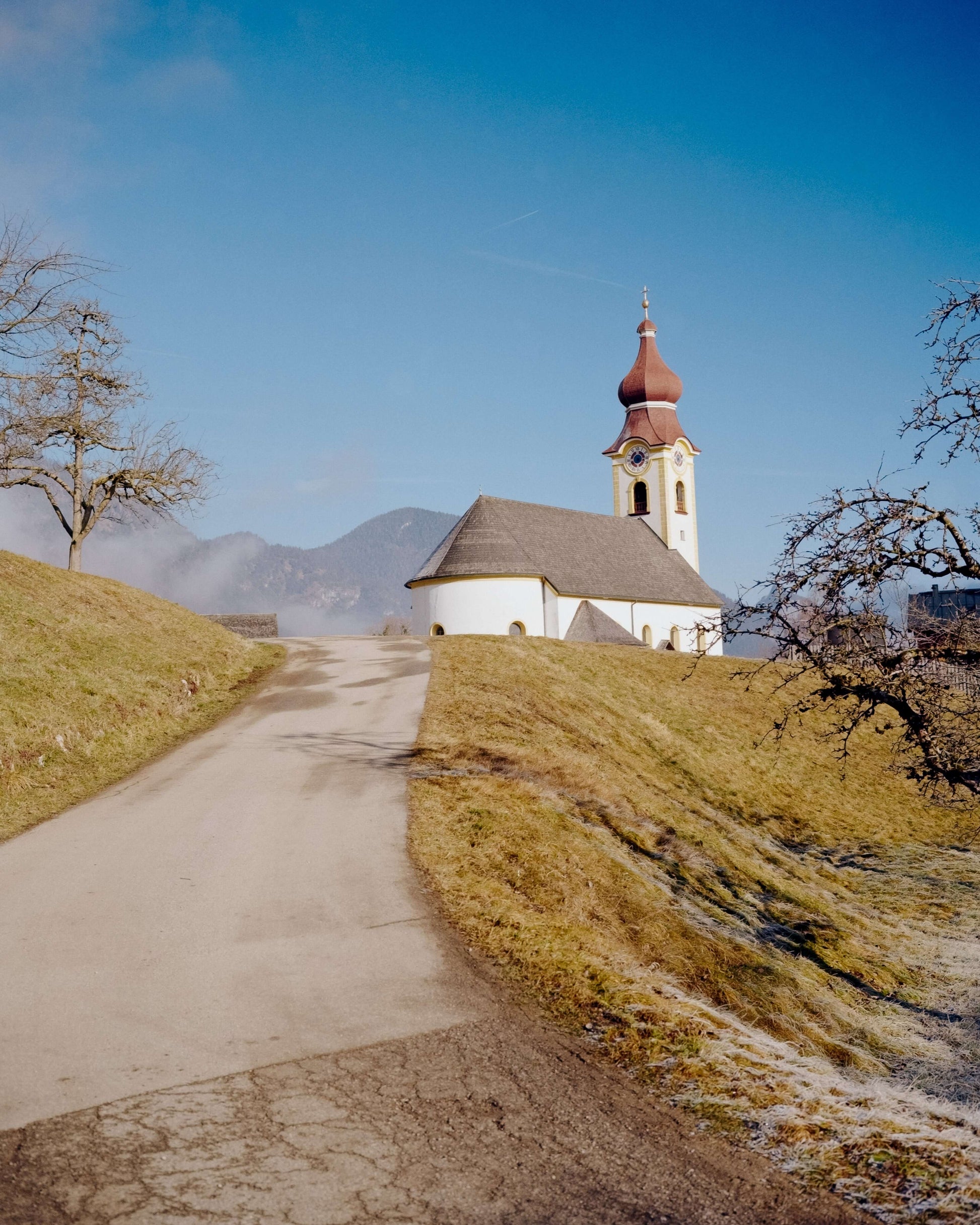 Kodak Eastman Gold 200 Color Negative Film captured a scenic church on a hill with a clear blue sky.