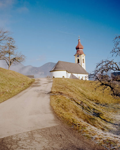 Kodak Eastman Gold 200 Color Negative Film captured a scenic church on a hill with a clear blue sky.