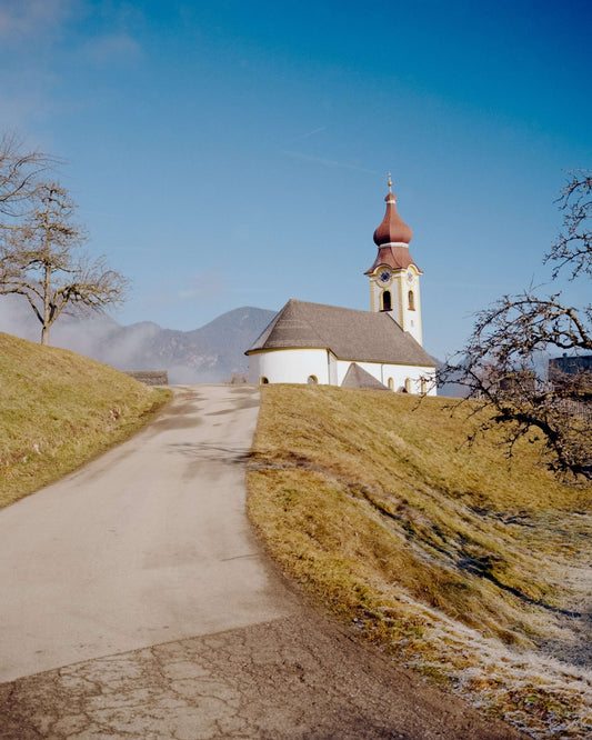 Kodak Eastman Gold 200 Color Negative Film captured a scenic church on a hill with a clear blue sky.