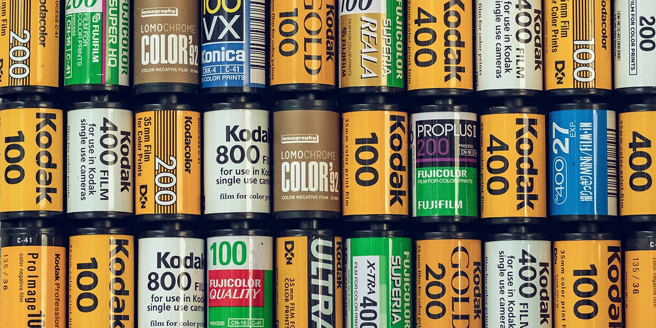 Many 35mm film canisters in a grid. Including Kodak, Fujifilm, Lomography and Konica. 