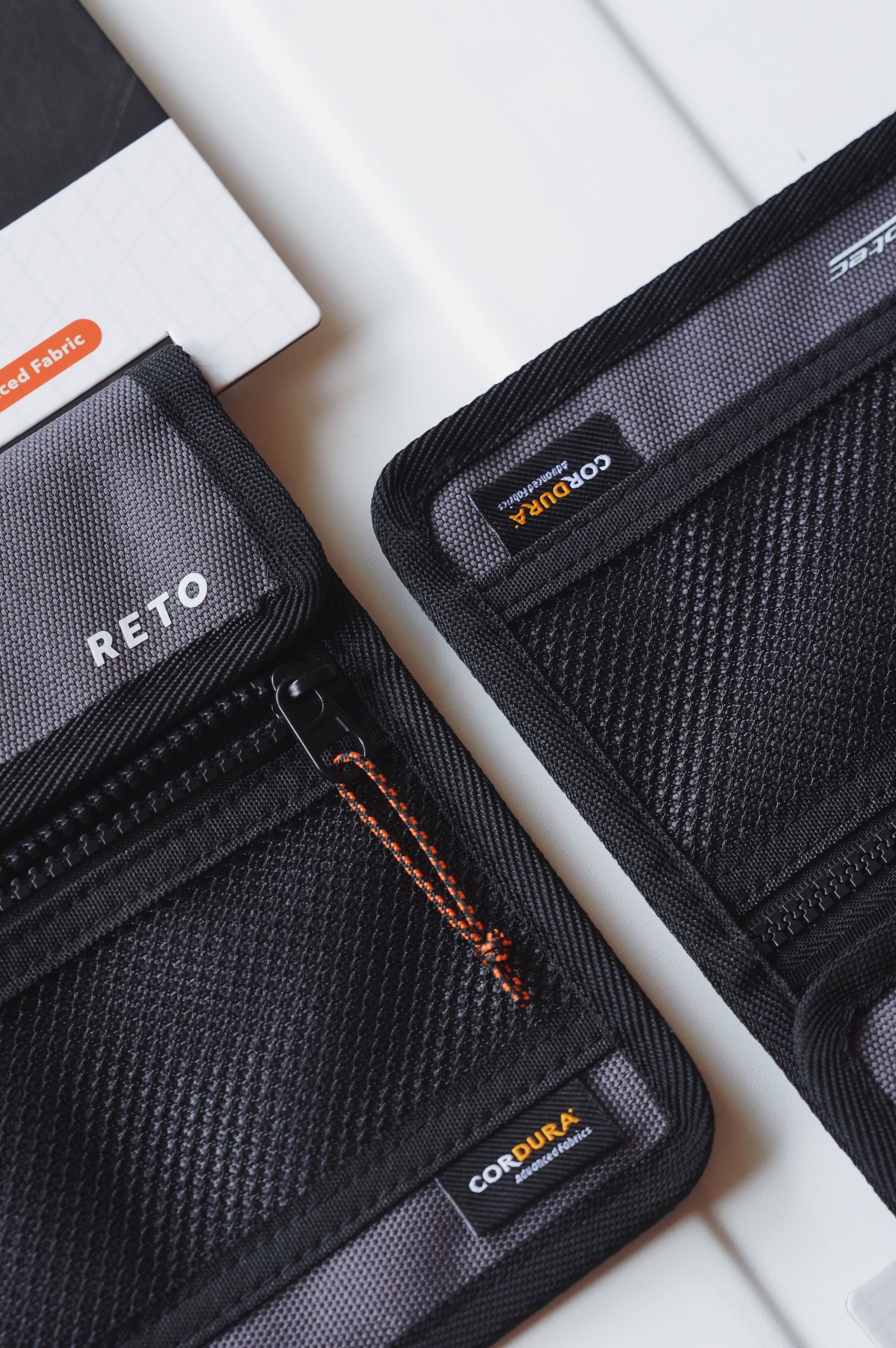 RETO Film X-Protec Bag (Medium) showing durable black fabric with CORDBURA labels and zipper compartments.