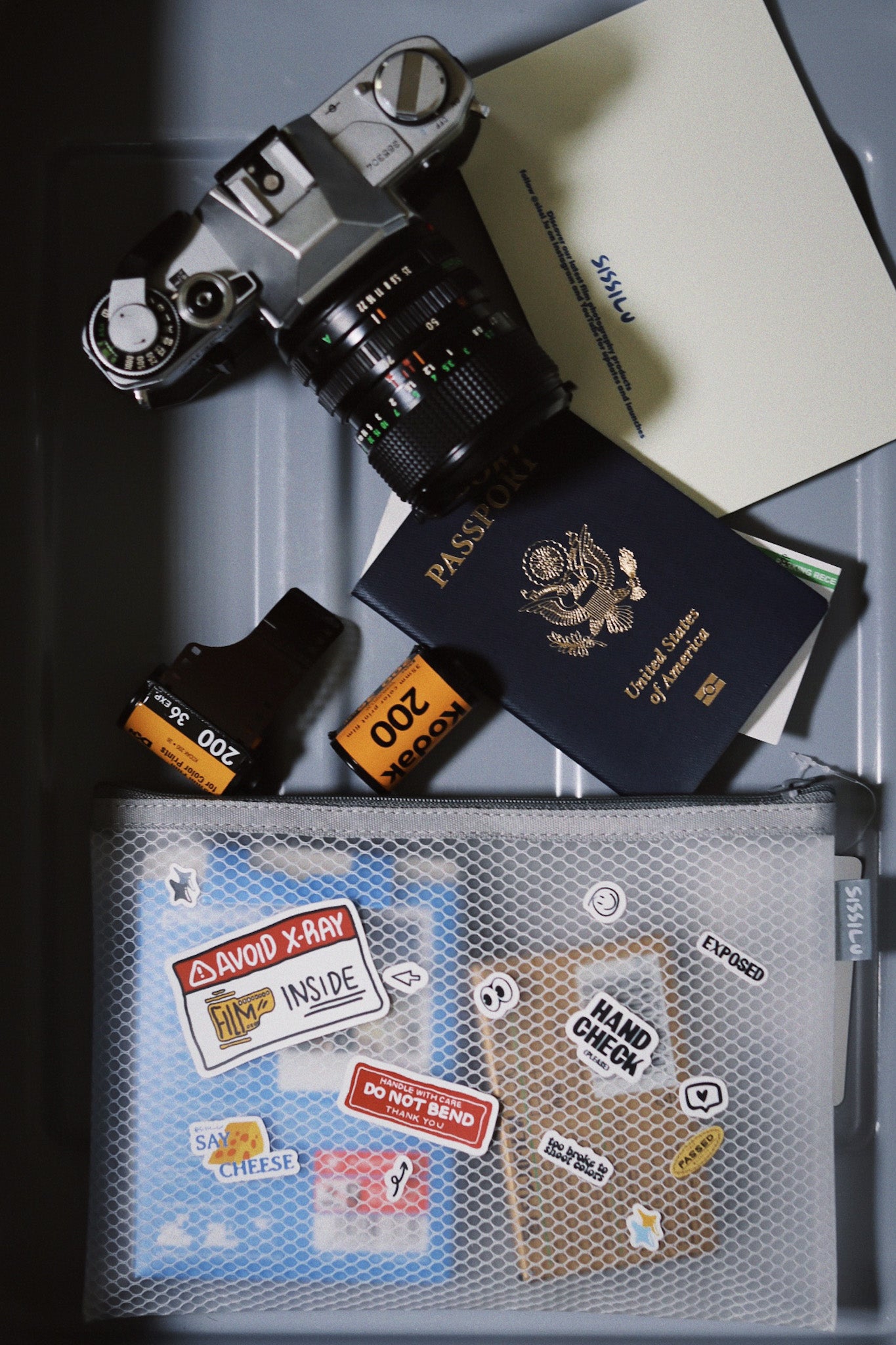 SissiLu "DO NOT X‑RAY" Film Pouch with camera, passport, and film canisters for travel safety.
