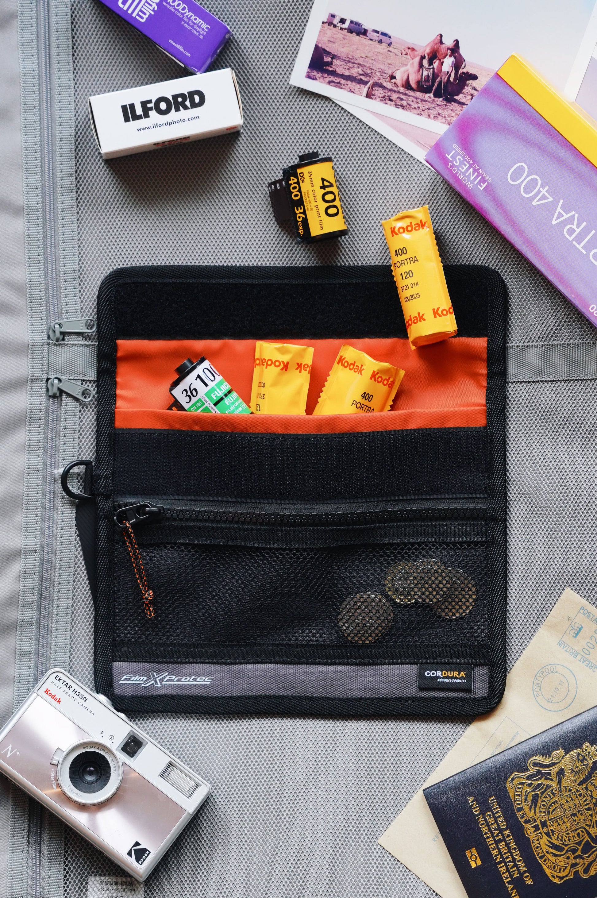 RETO Film X-Protec Bag (Small) with film rolls and camera on a travel packing layout.