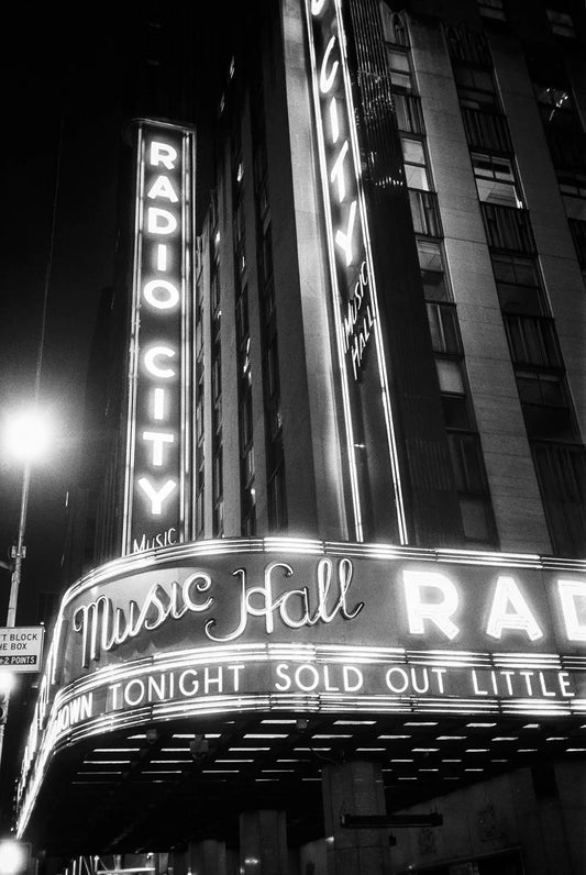 Radio City Music Hall marquee illuminated at night in black and white, featuring sold out event sign shot on Ilford FP4 Plus 125