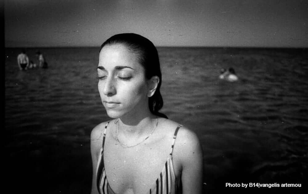 Film Photography Project Dracula 64 image in black and white of a girl next to a pool of water.