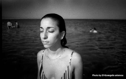 Film Photography Project Dracula 64 image in black and white of a girl next to a pool of water.