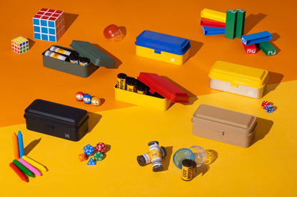 Kodak 135 Film Case (Silver) and various accessories on an orange background showcasing organization and style.