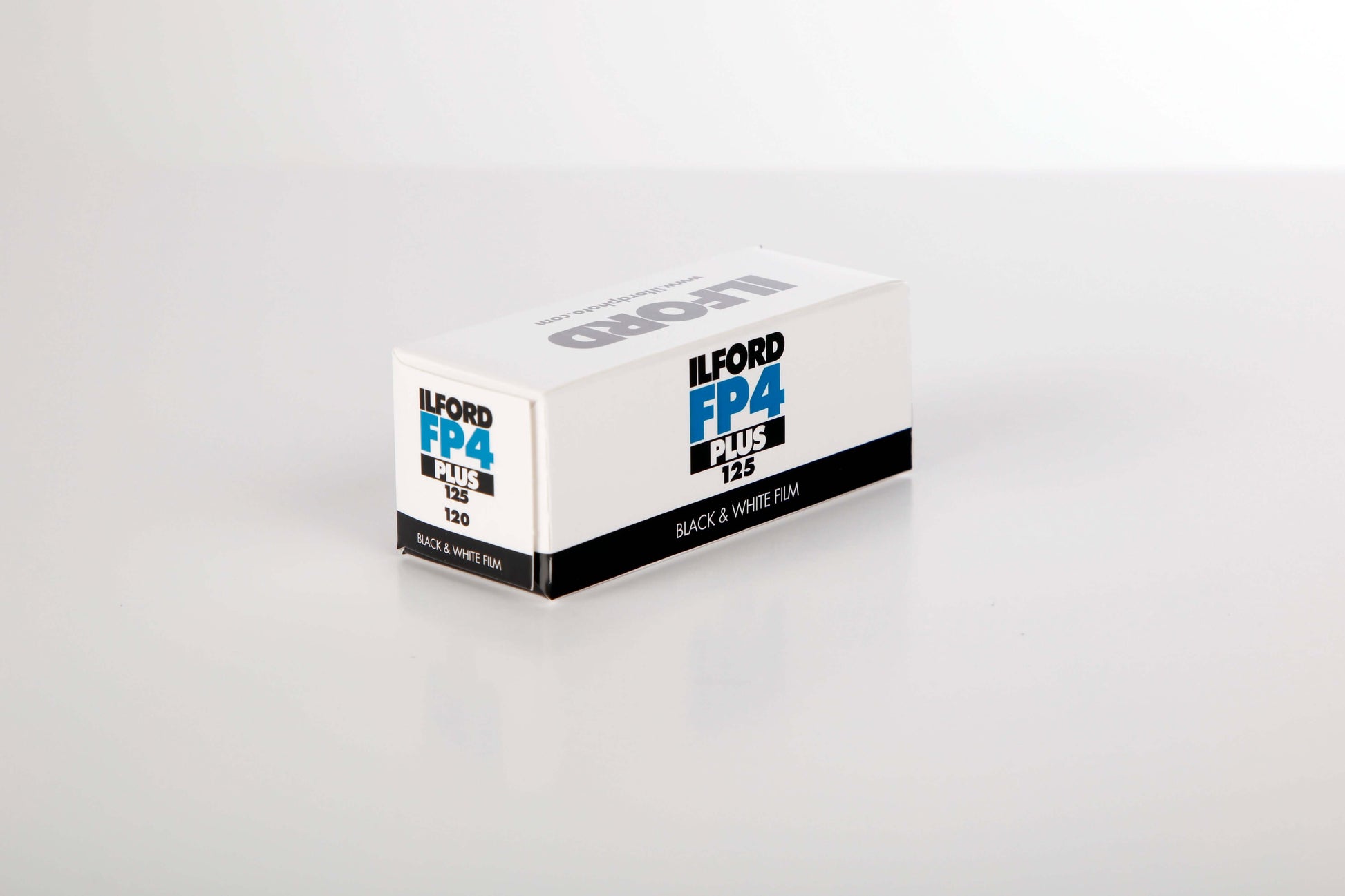 Ilford FP4 Plus 120 roll black and white film packaging, ISO 125, known for fine grain and sharpness.