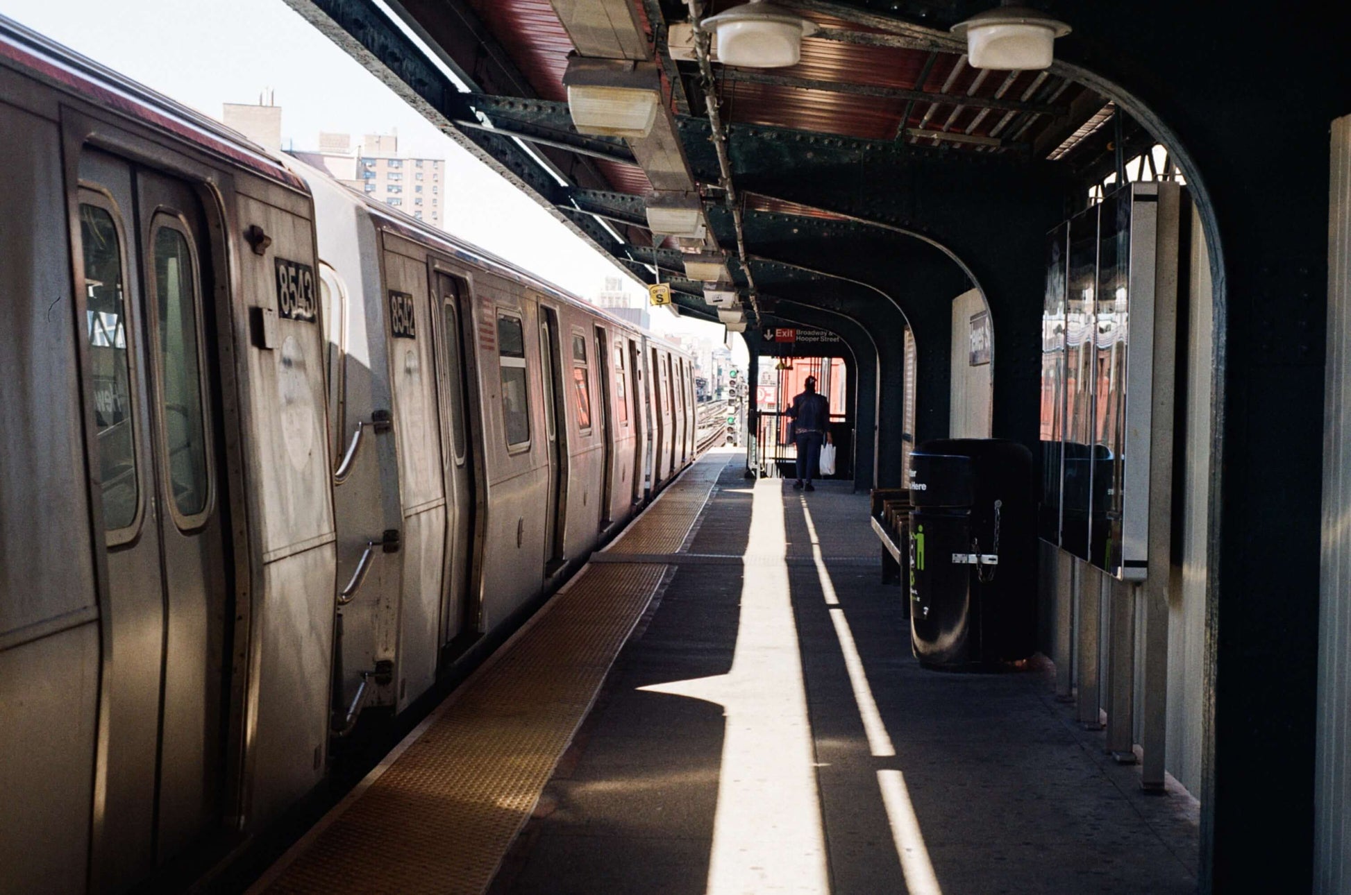 Subway station platform with passing train and a lone figure, captured on Kodak Kodacolor 100 Color Negative Film (35mm, 36 Exposures).