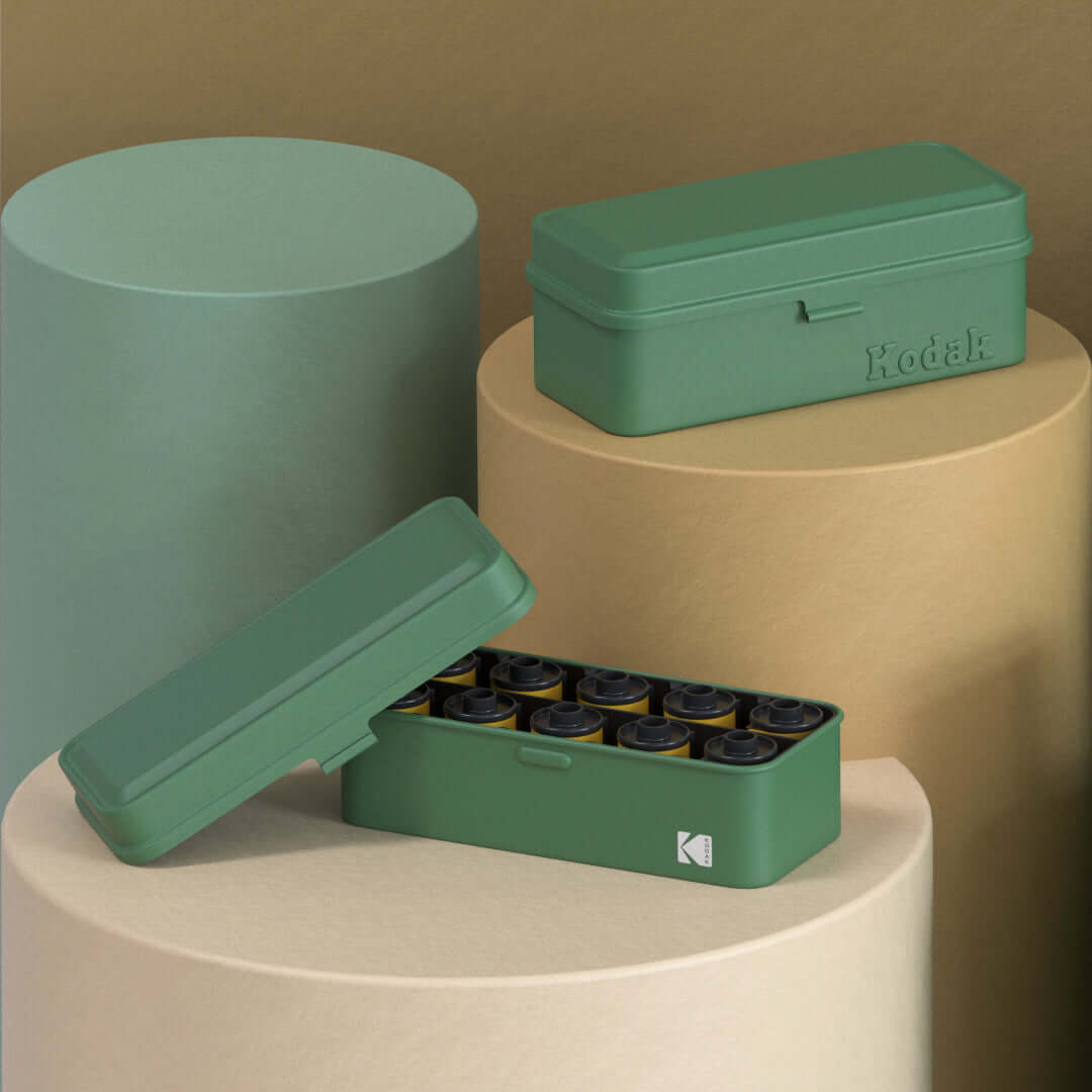 Kodak 120/135 Film Case (Green) displayed with film rolls in an artistic composition.