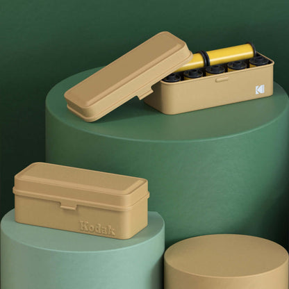 Kodak 120/135 Film Case (Beige) displayed with film rolls in an artistic composition.
