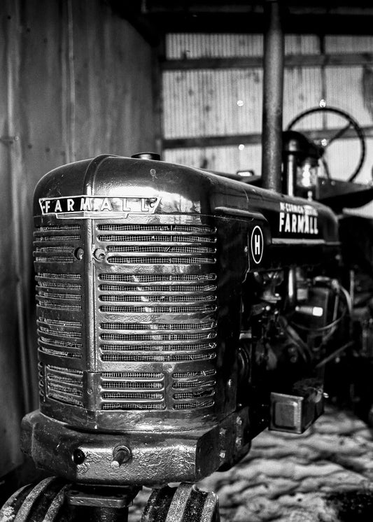 Farmall tractor in black and white, showcasing vintage machinery details and rustic charm, shot on Ferrania P30.