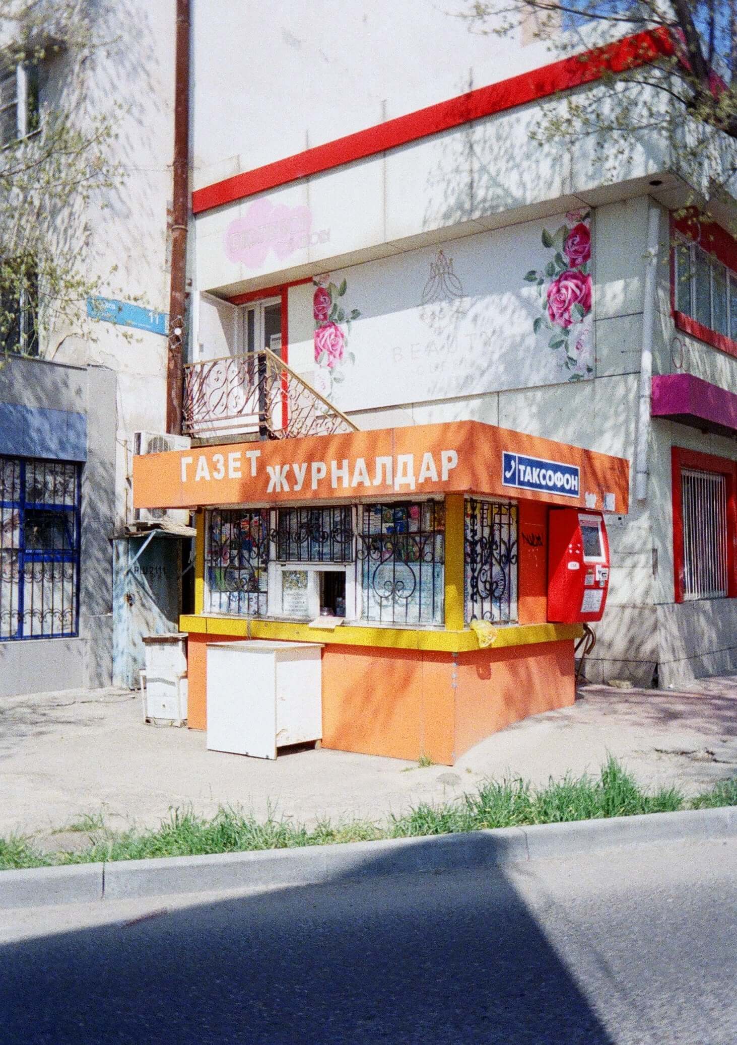 Kodak Ektar H35N Half Frame Film Camera (BT21 Edition) sample photo of a newsstand in bright colors