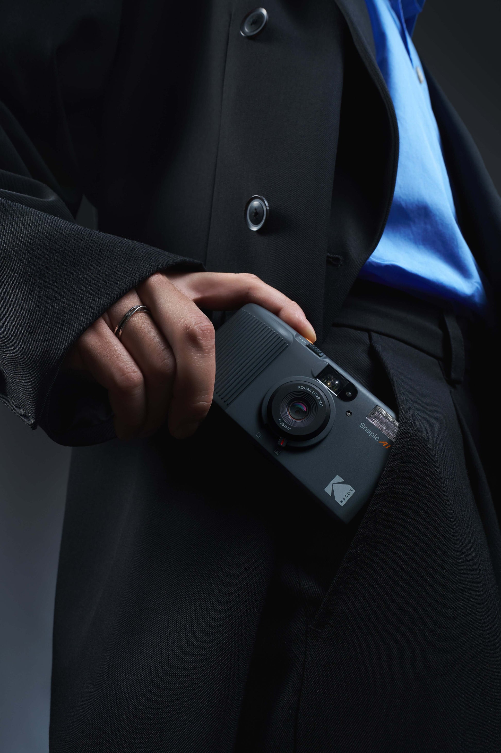 Person pulling out a Kodak Snapic A1 35mm camera from their pocket.