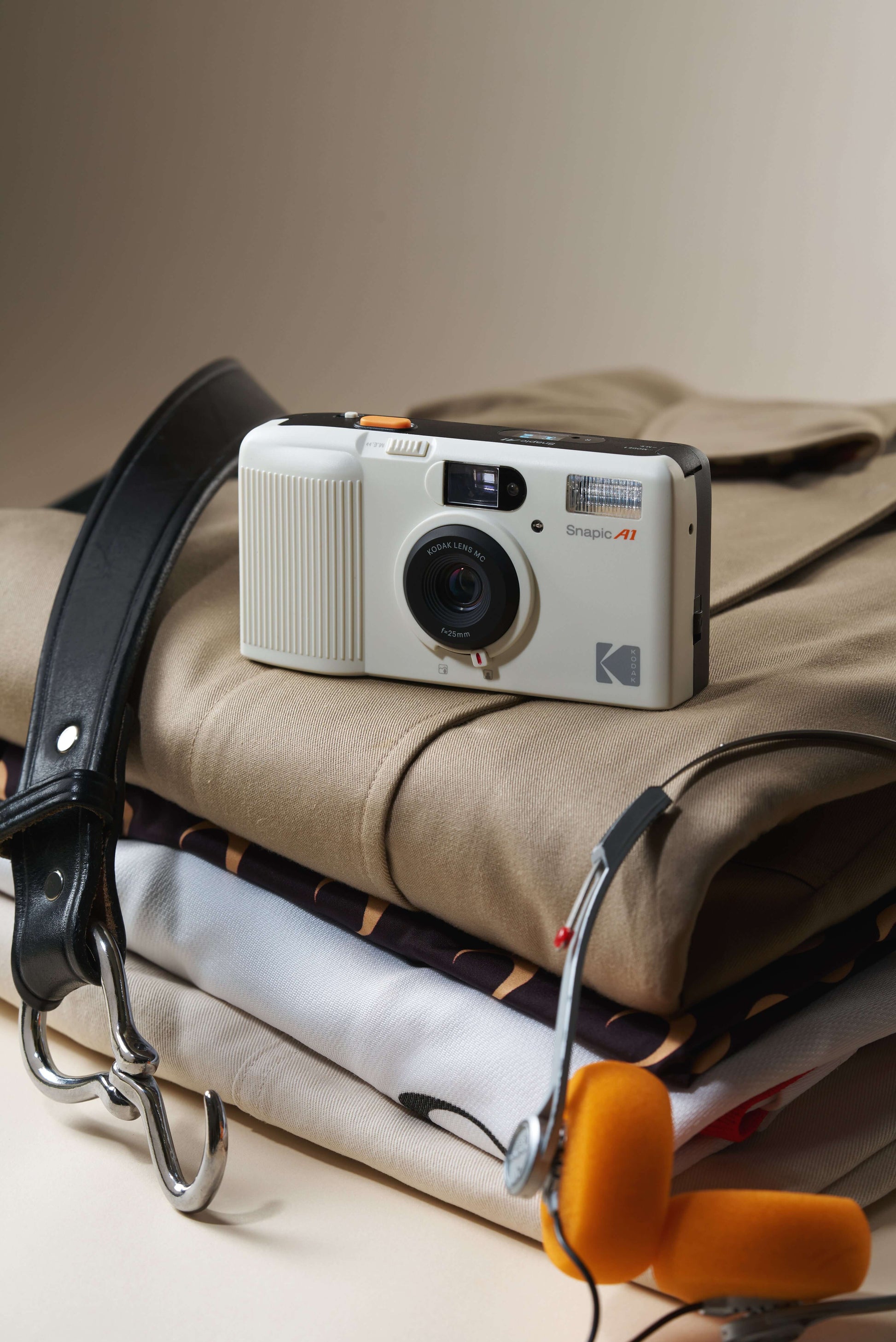 Kodak Snapic A1 35mm camera sitting on a stack of clothes.