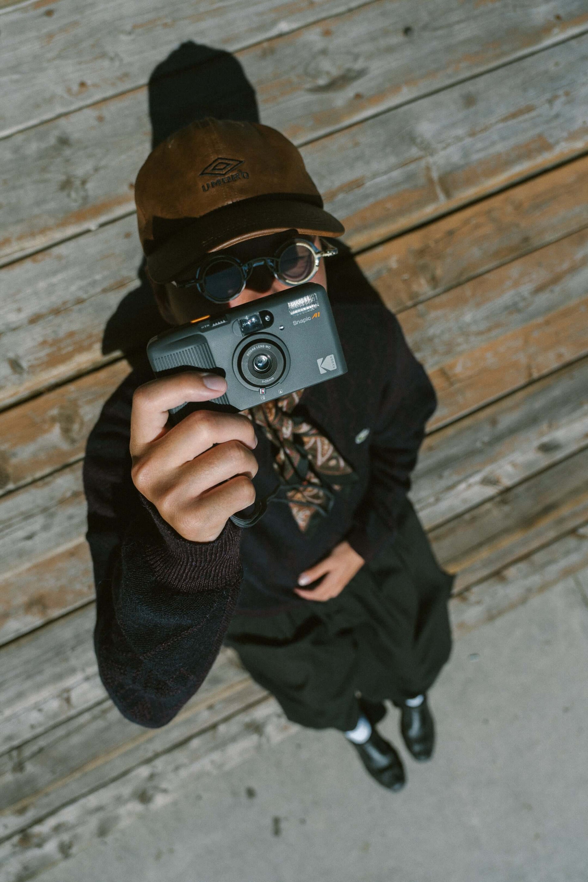 Person holding the Kodak Snapic A1 35mm camera pointing at the ceiling.