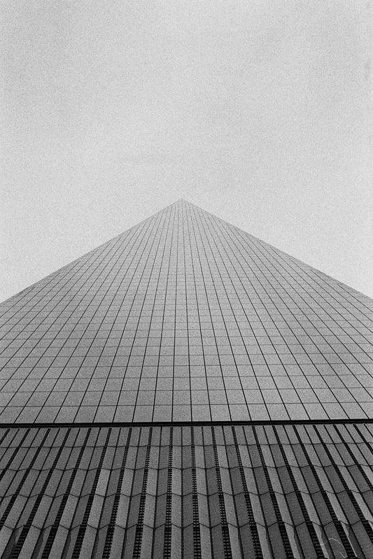 A striking black and white photograph of a skyscraper captured with Kodak Tri-X 400 Single-Use Camera (27 Exposures).