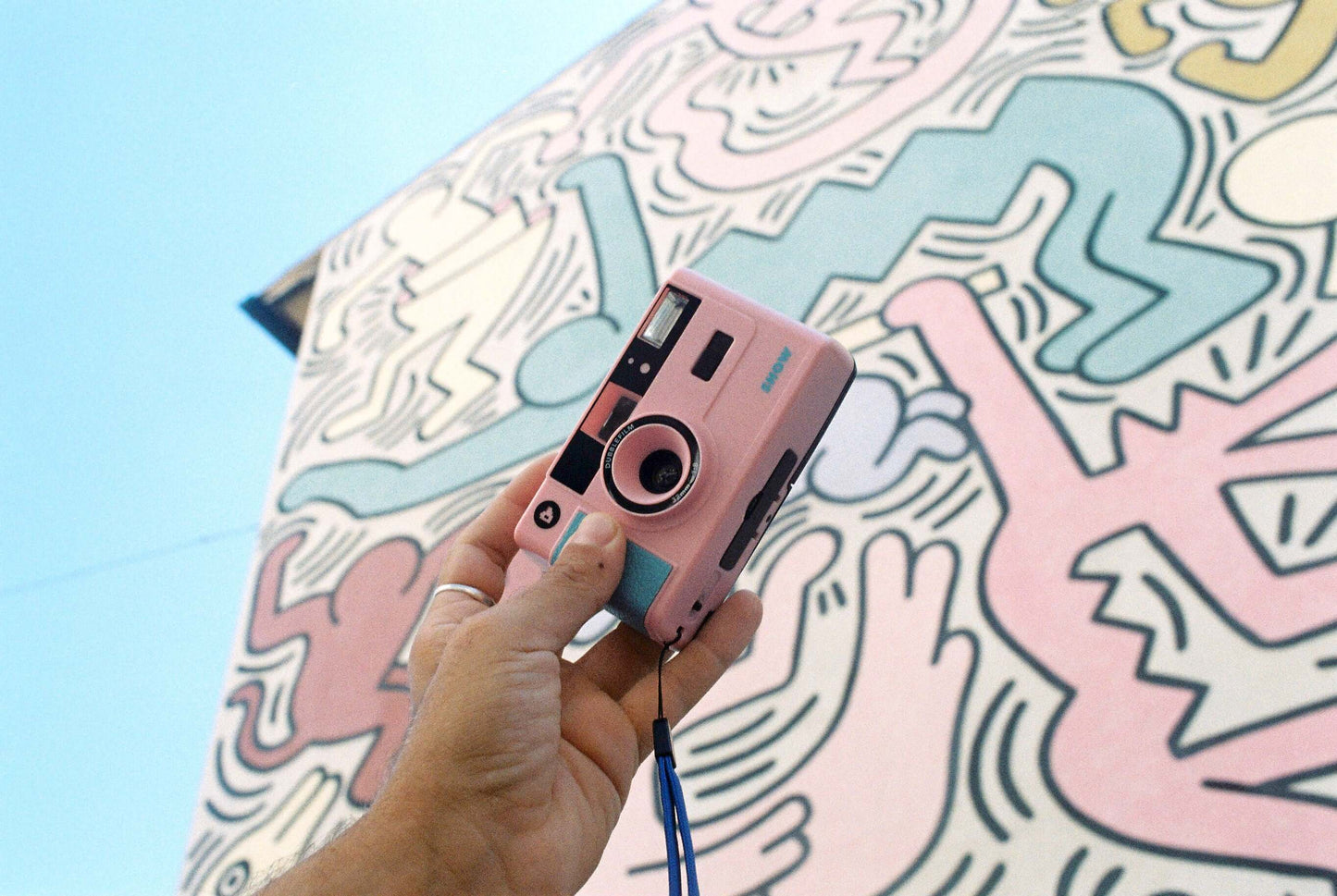 Dubblefilm SHOW 35mm Reusable Camera (Pink) — compact pink reusable camera with built-in flash, carrying strap, and case for on-the-go photography