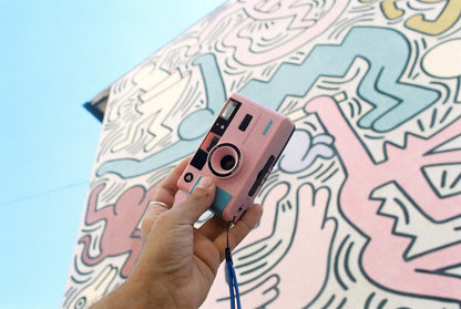 Dubblefilm SHOW 35mm Reusable Camera (Pink) — compact pink reusable camera with built-in flash, carrying strap, and case for on-the-go photography