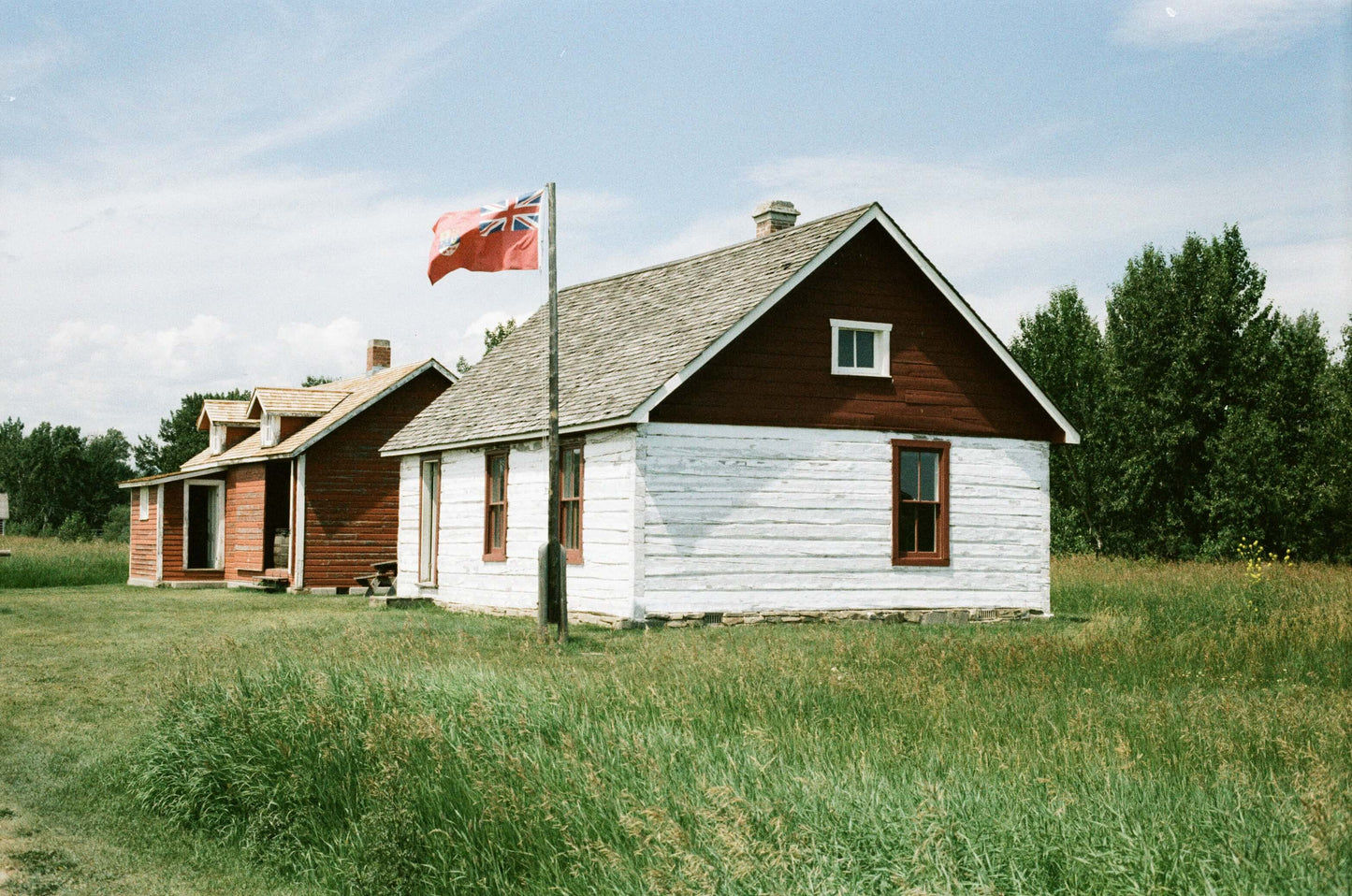 Street Candy Tasty 200 Color Negative Film displayed with historic wooden houses and a flag in a green field.