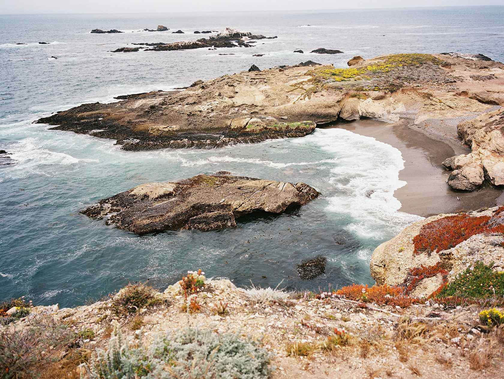 Scenic view of rocky coastline and ocean waves at a coastal landscape.