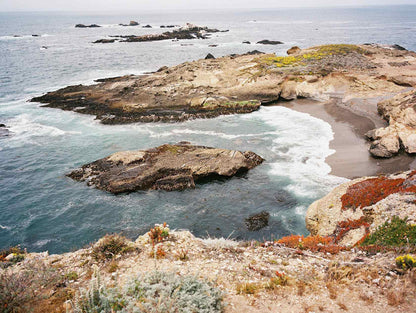 Scenic view of rocky coastline and ocean waves at a coastal landscape.